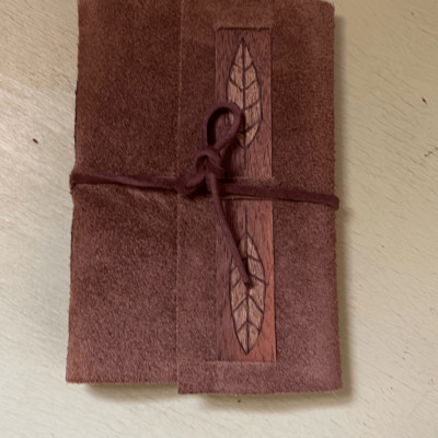 Little leather bound travel carry notebook.-image